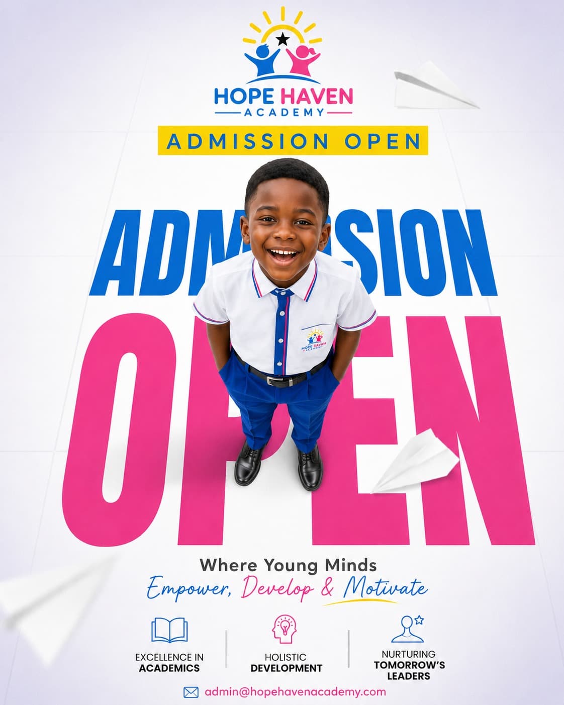 A smiling Hope Haven Academy student in uniform, photographed from above standing on giant Admission Open lettering